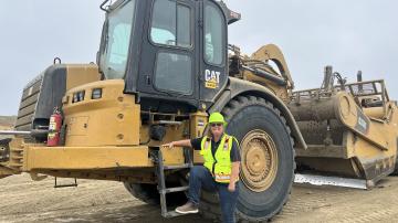 picture of our employee next to a machine at the landfill