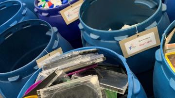 Donation buckets fill with empty CD containers and plastic eggs.
