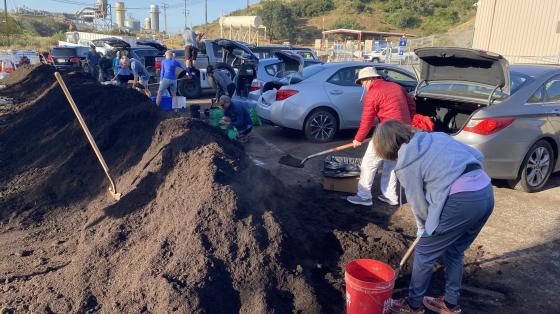 People picking up compost