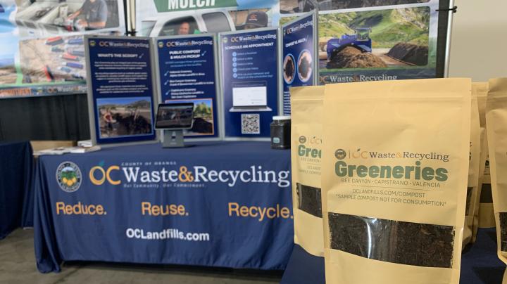 OC Waste & Recycling booth with display and sample compost bags.