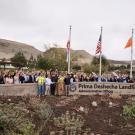 Group photo at Prima Deshecha Landfill. Group of people in front of flags.