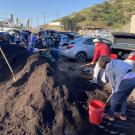 People picking up compost