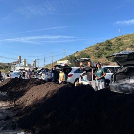 People shoveling compost