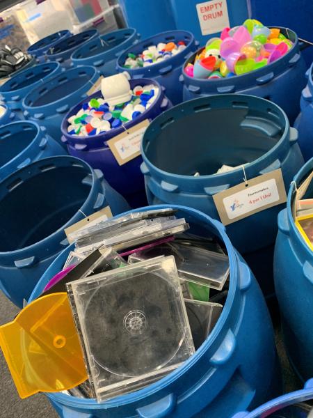 Donation buckets fill with empty CD containers and plastic eggs.