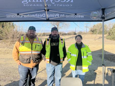 Three OC Waste & Recycling employees, smiling at the Prima Open House for landscapers.
