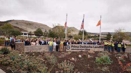 Group photo at Prima Deshecha Landfill. Group of people in front of flags.